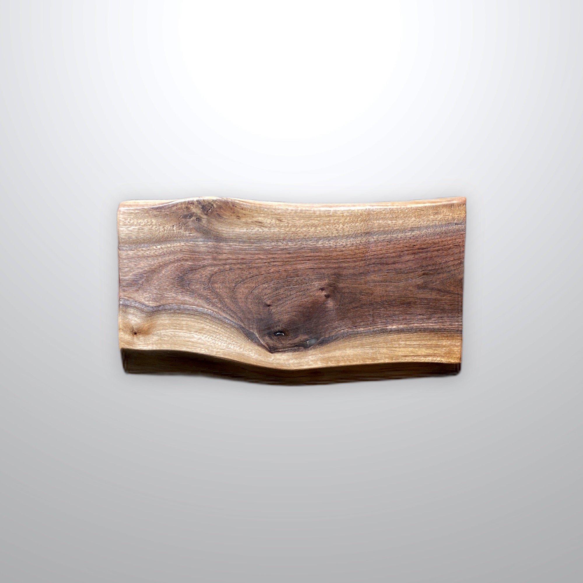 Live edge walnut cutting board; designed and made by Joh Wayne Hill of DeathGhost Studios